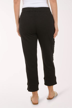 A woman wearing black capri pants.