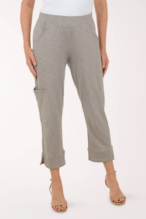 A woman wearing grey capri pants.