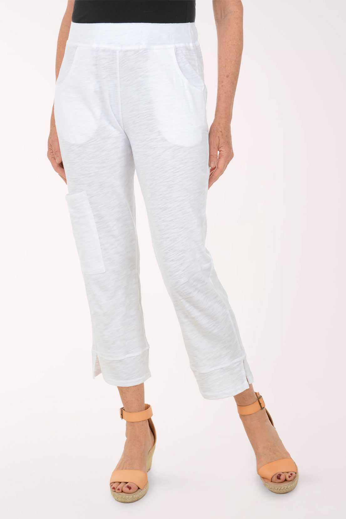 A woman wearing white capri pants.