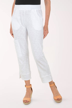 A woman wearing white capri pants.