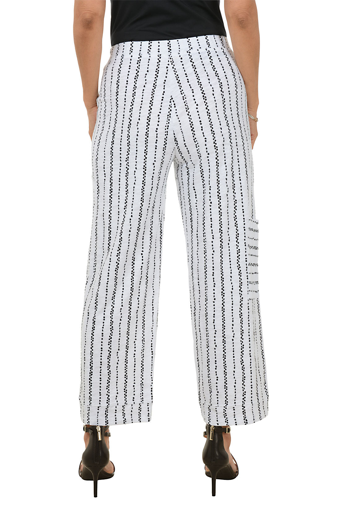 Woman wearing black and white striped ankle pants.