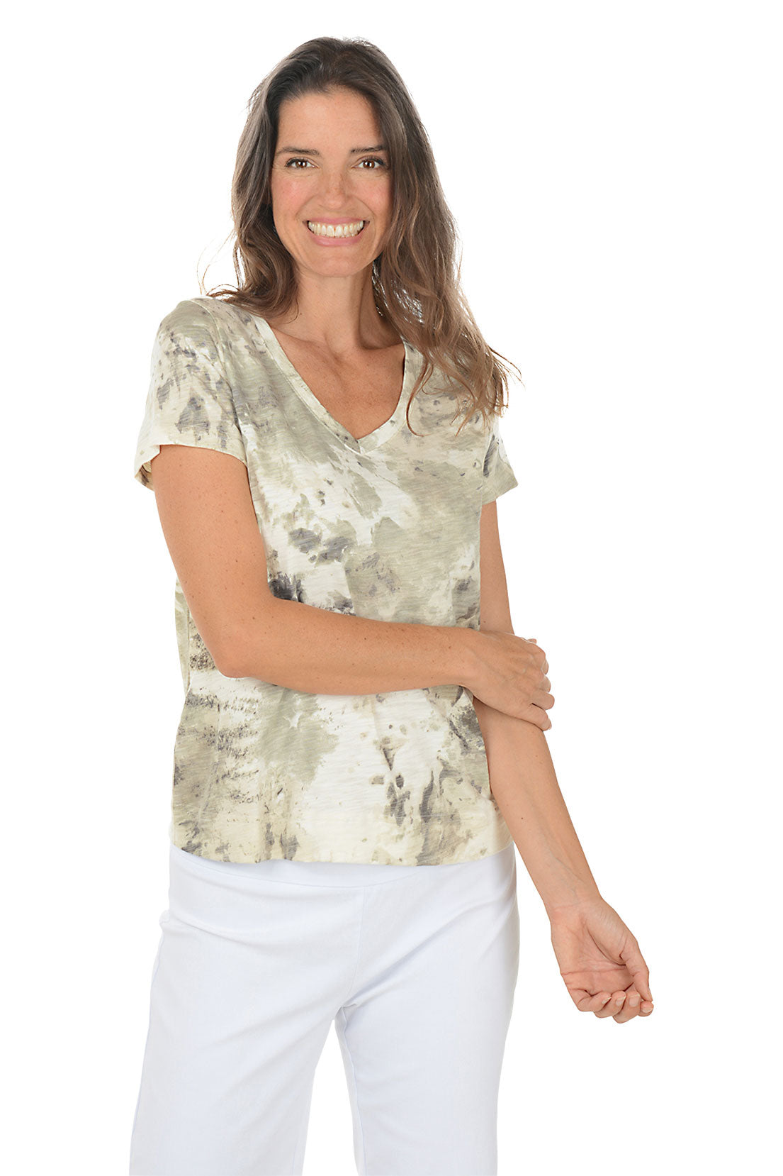 Woman wearing a patterned top and white pants on a white background. Second front shot.