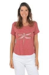Woman wearing a red t-shirt with a dragonfly design on a white background. Second front shot.