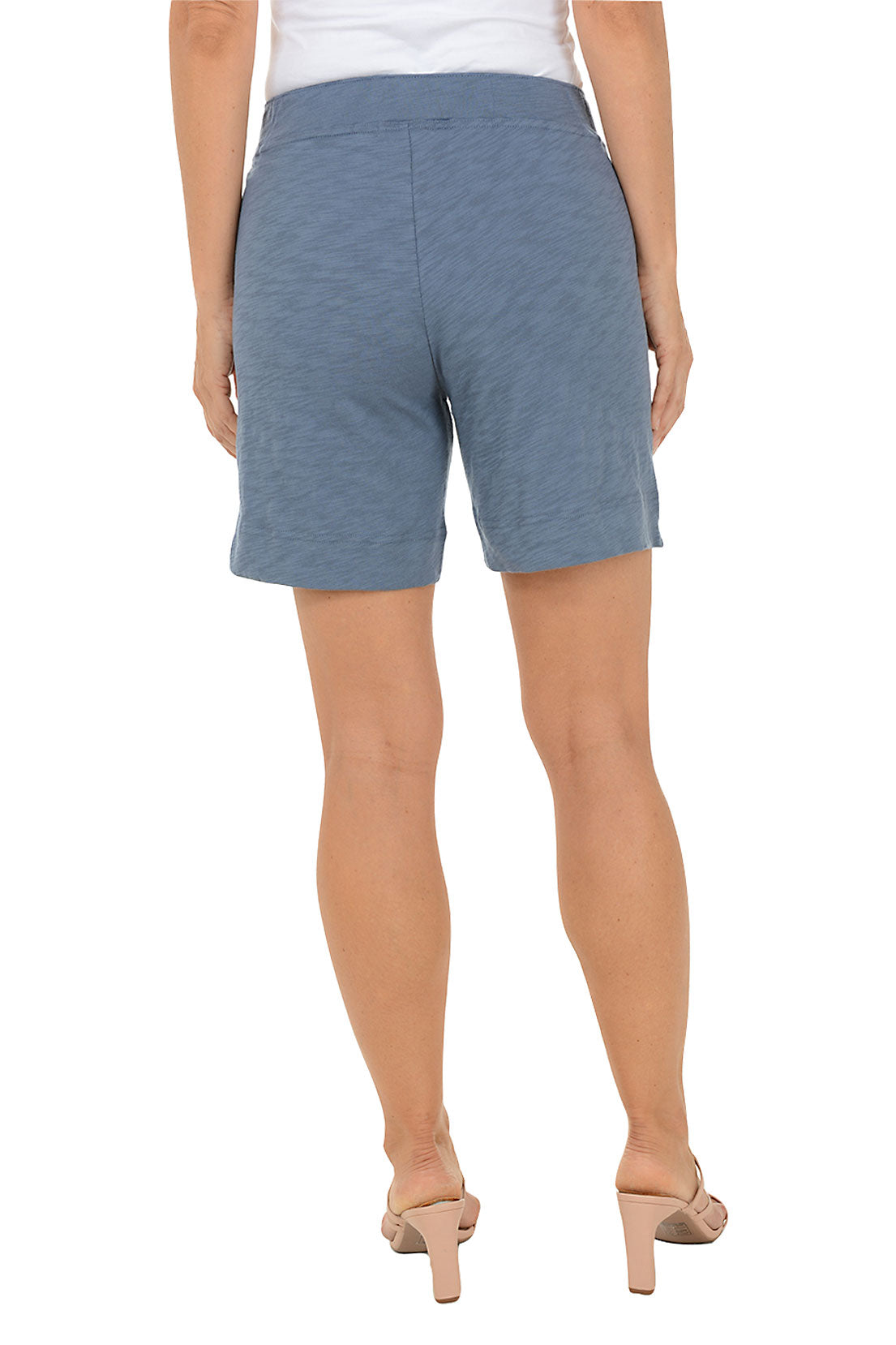 Blue shorts worn by a person on a white background. Back shot.