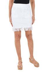 White skirt with fringe hem worn by a person on a white background