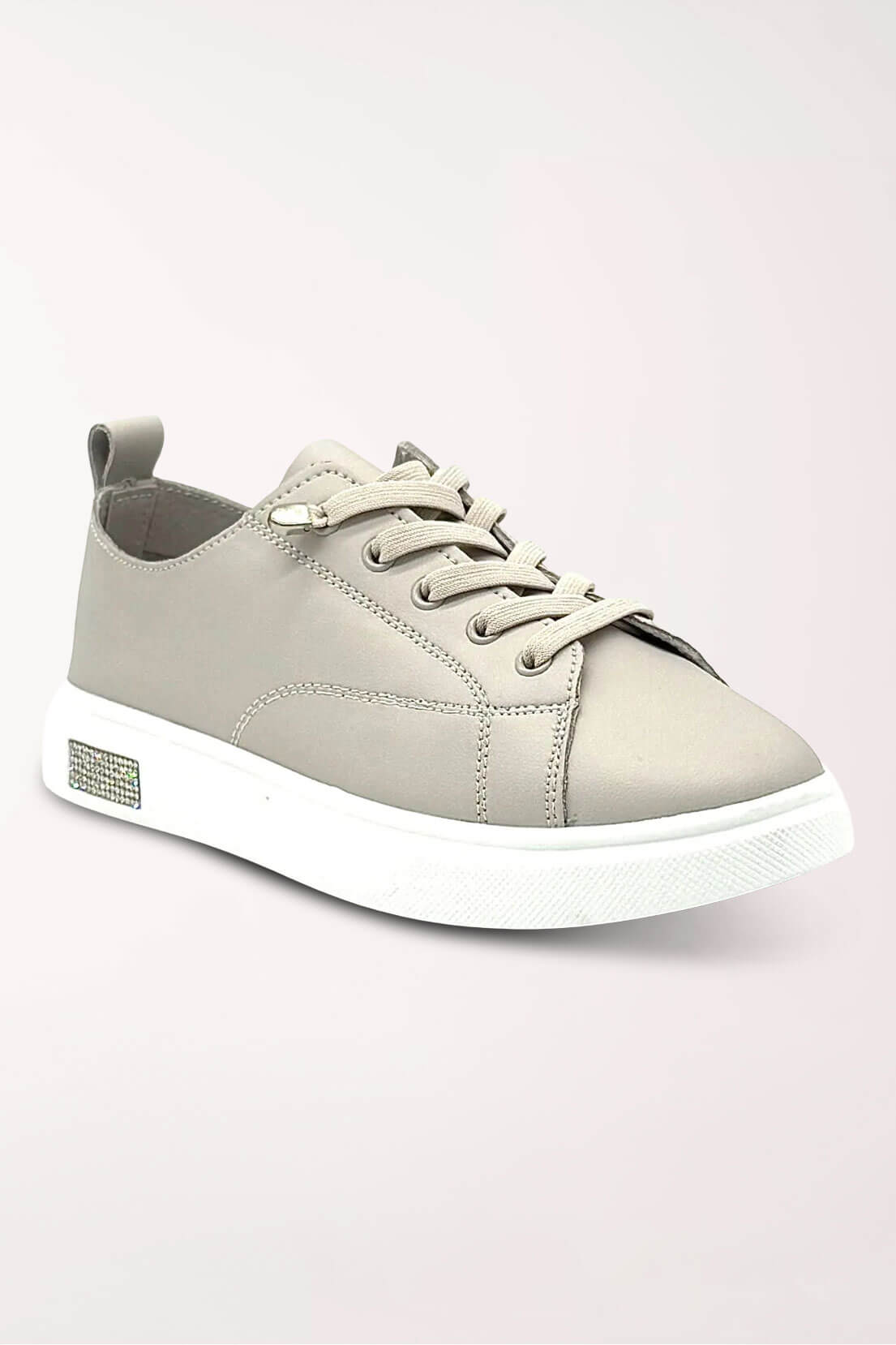Light taupe leather lace-up sneaker with elastic laces, a slim white sole and a small rhinestone accent on the outer heel, shown at an angle.