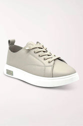 Light taupe leather lace-up sneaker with elastic laces, a slim white sole and a small rhinestone accent on the outer heel, shown at an angle.