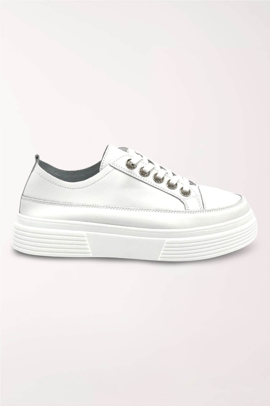 Side profile of the white leather platform sneaker showing the ridged platform sole.