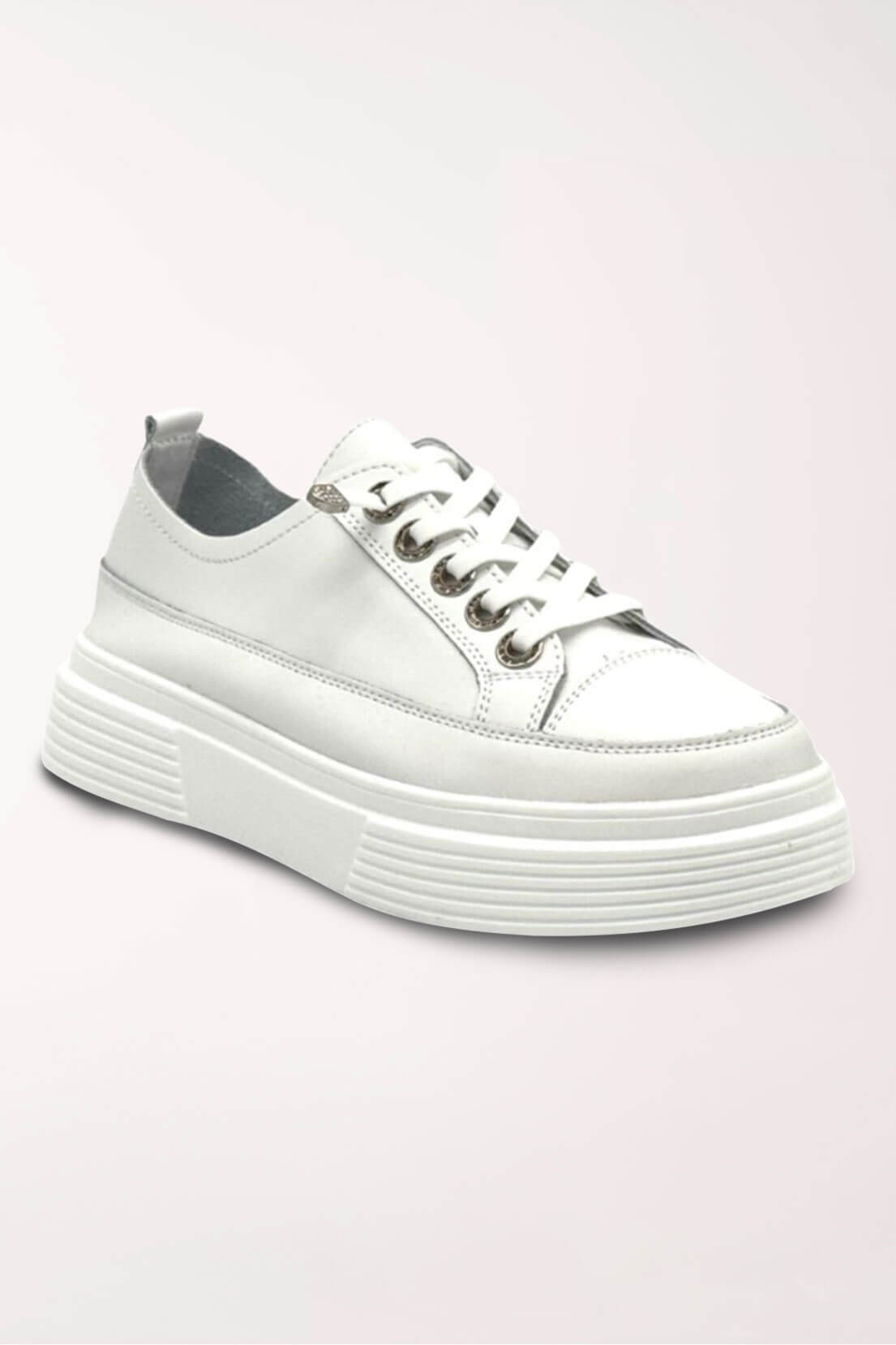 White leather low-top sneaker with a chunky ridged platform sole, white elastic laces and rhinestone-studded grommets, shown at an angle.
