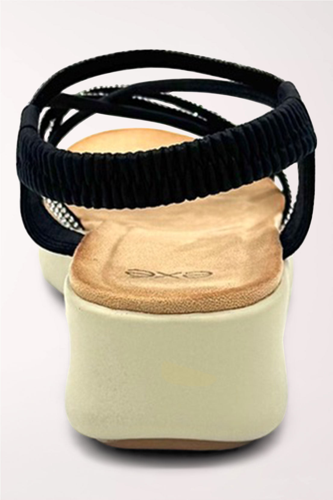 Back view of the black wedge sandal showing the wide elastic slingback strap and cream wedge heel.