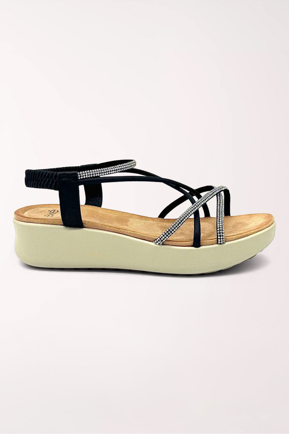 Side profile of the black rhinestone strappy wedge sandal showing the cream wedge height.