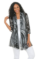 Woman wearing a black and gray patterned cardigan on a white background.