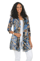 Woman wearing a patterned cardigan over a white top and pants on a white background.