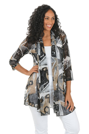 Woman wearing a patterned jacket over a white top on a white background.