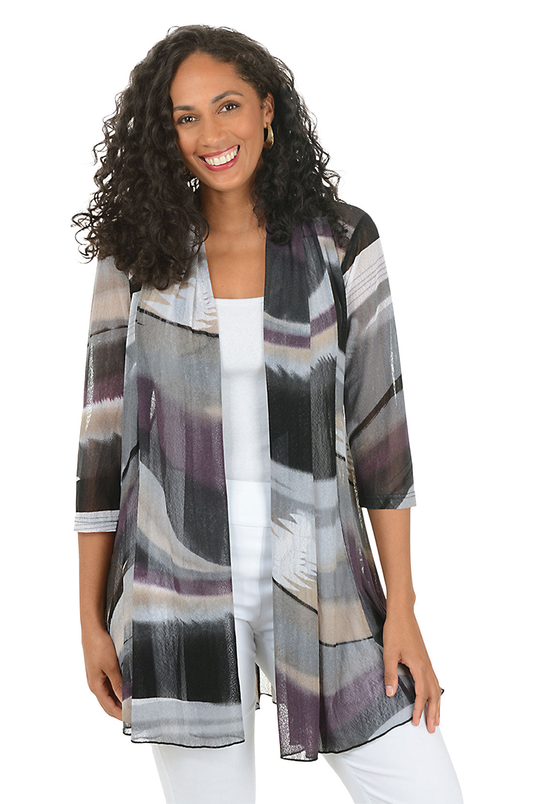 Woman wearing a patterned cardigan over a white top on a white background.