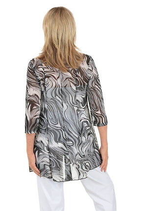 Woman wearing a patterned jacket on a white background. Back shot.