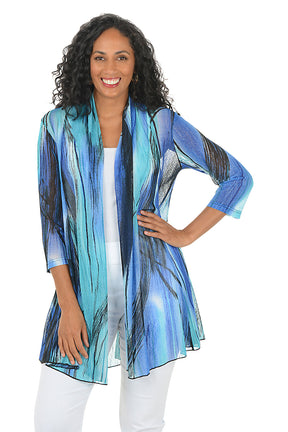 Woman wearing a blue and green patterned kimono-style jacket on a white background.