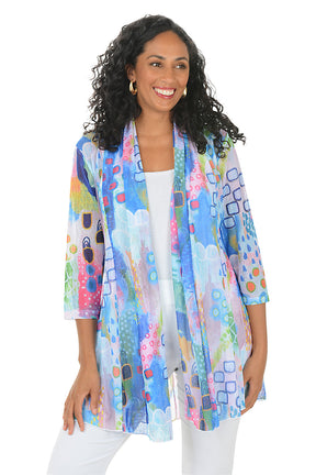 Woman wearing a colorful patterned jacket on a white background.