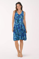 Woman wearing a blue patterned dress on a white background
