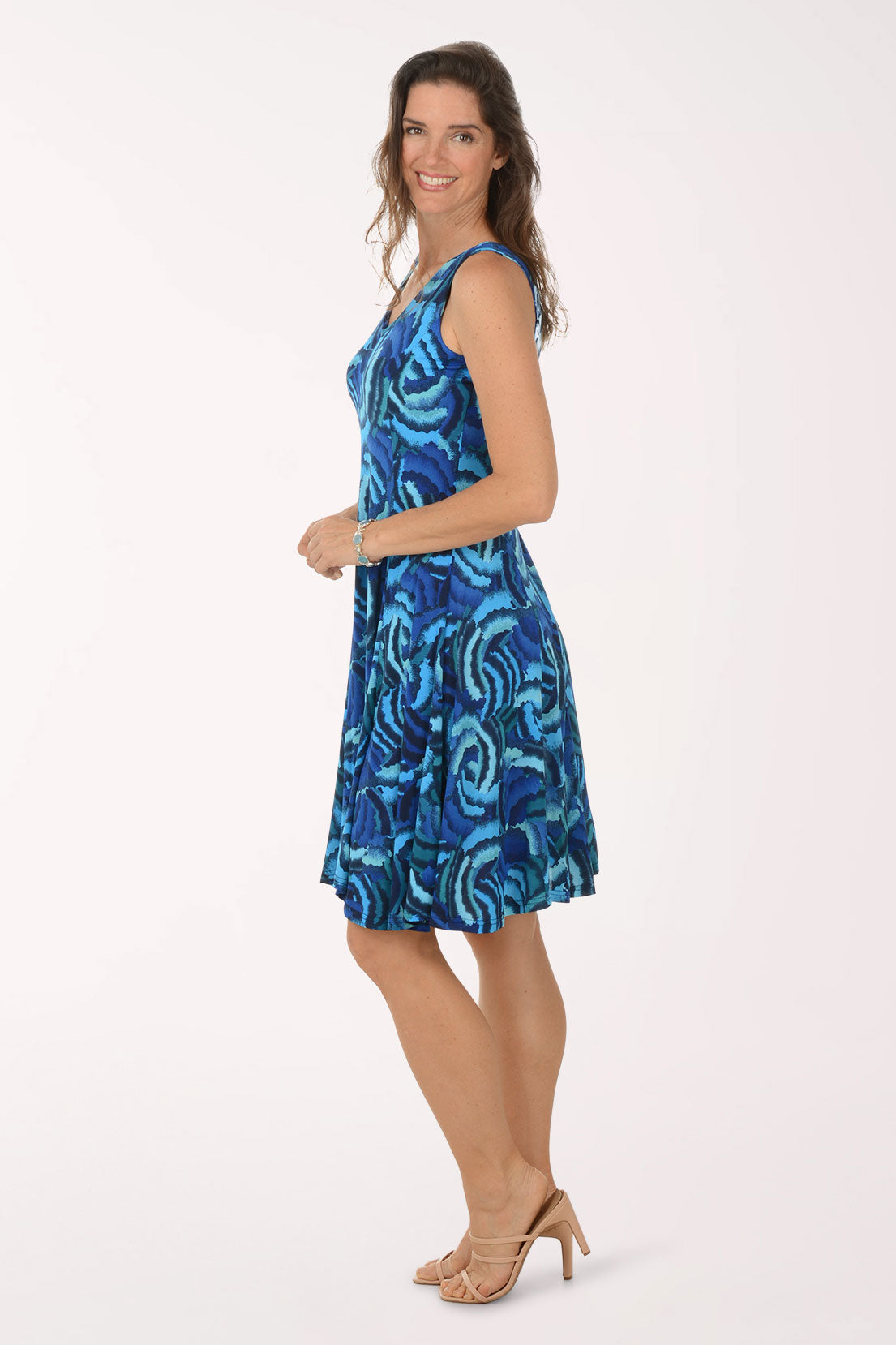 Woman wearing a blue patterned dress on a white background