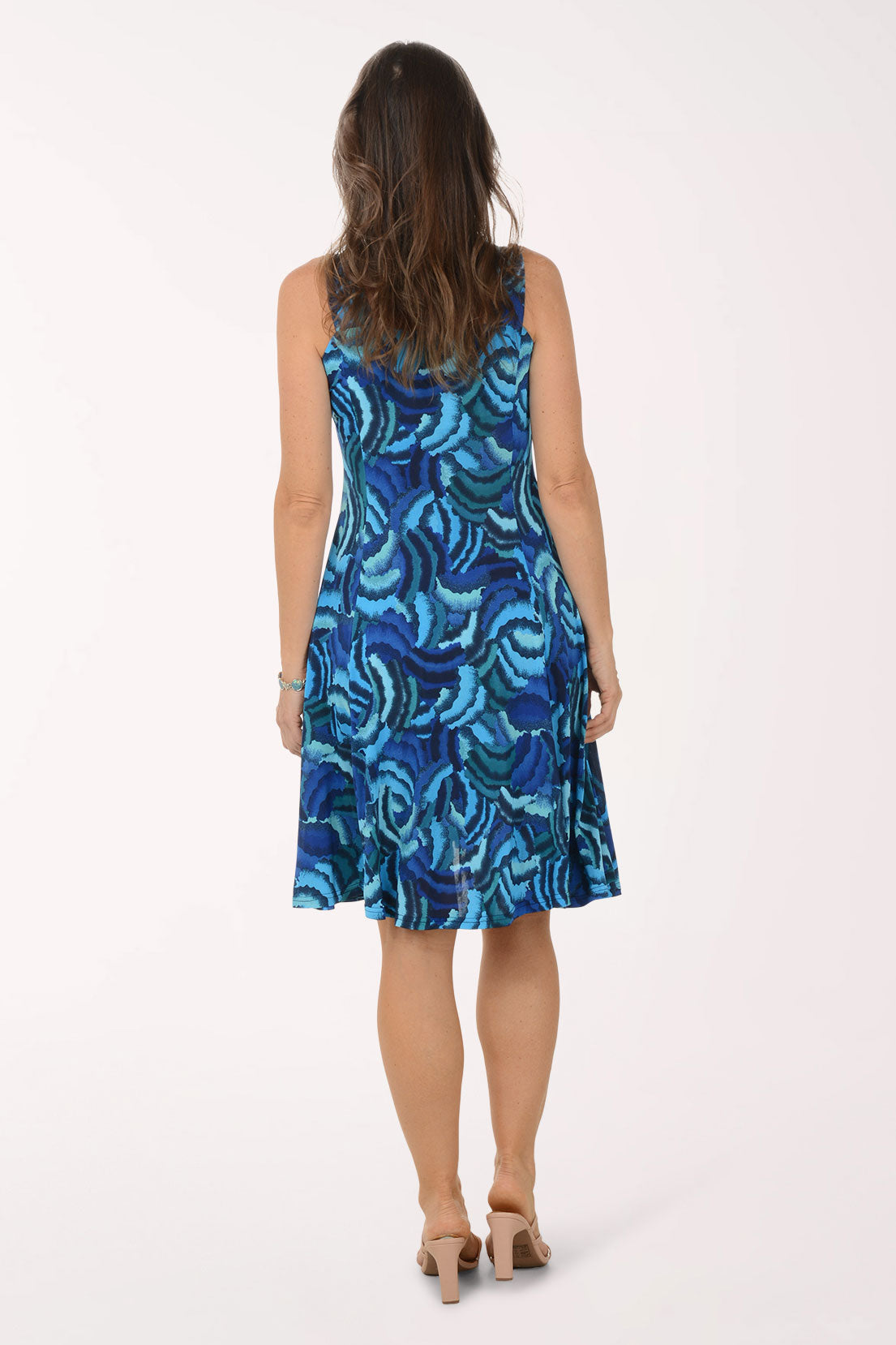 Woman wearing a blue patterned dress on a white background