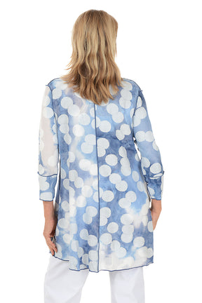 Woman wearing a blue and white patterned cardigan on a white background. Back shot.