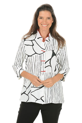 Woman wearing a black and white patterned blouse on a white background. Second front shot.