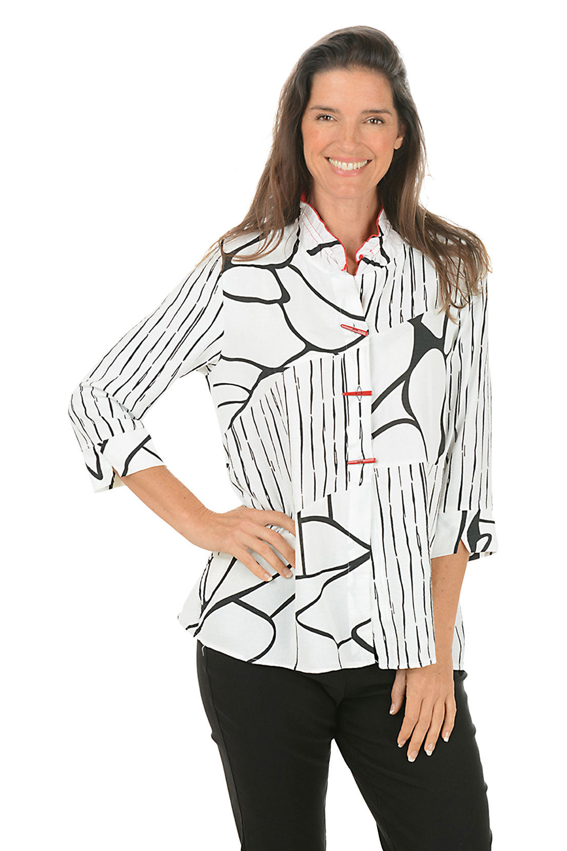 Woman wearing a black and white patterned blouse on a white background.