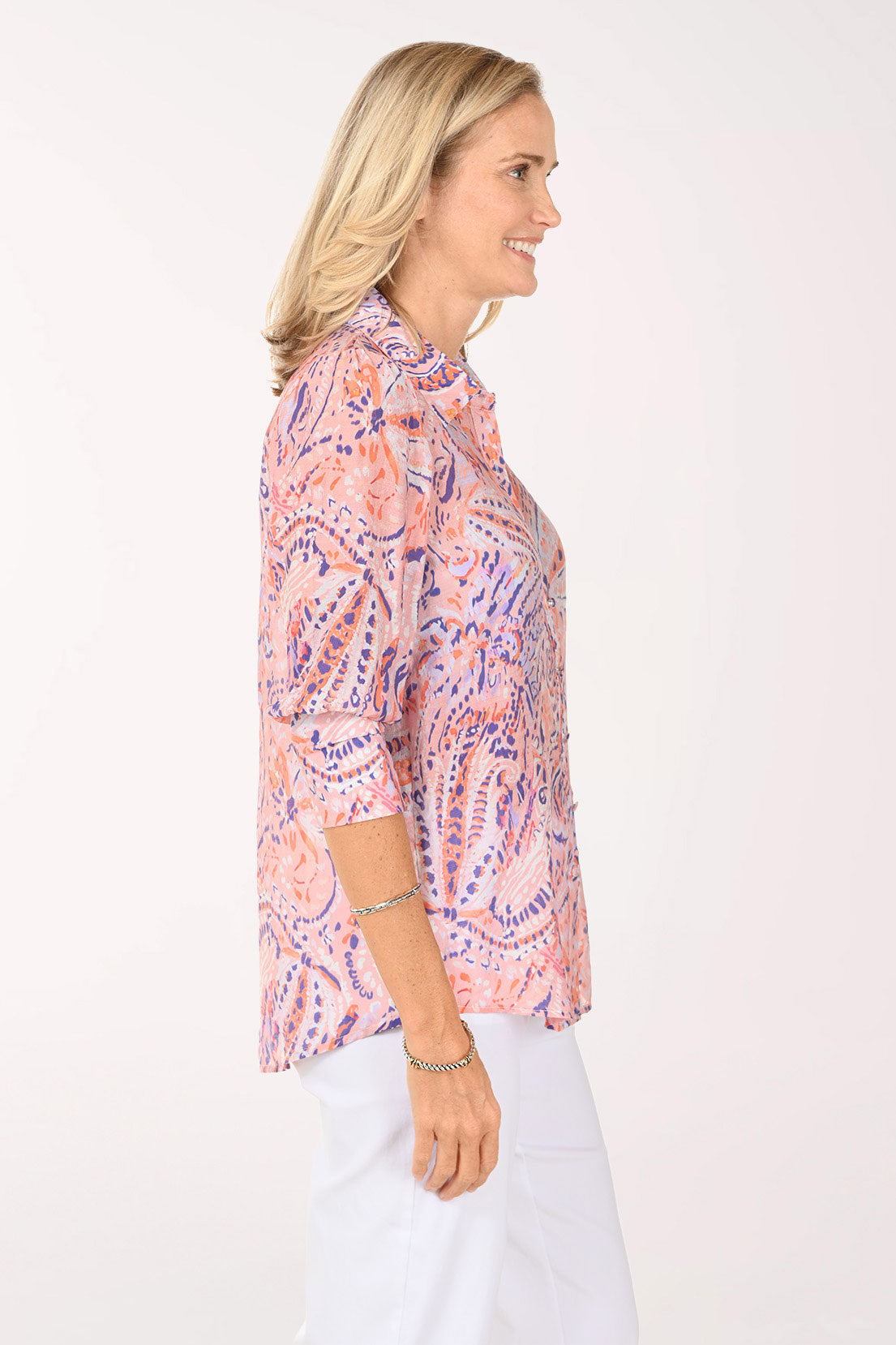 Woman wearing a 3/4 sleeve pink paisley top