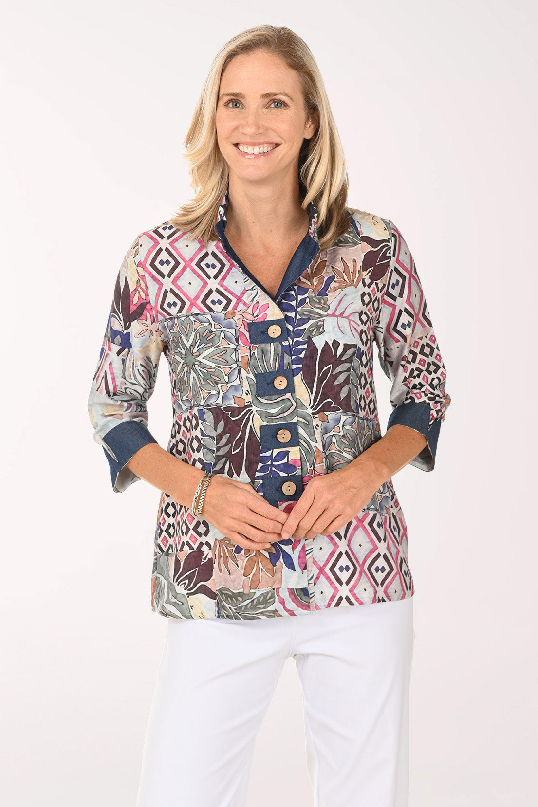 Woman wearing a multi colored button down top with 3/4 sleeves
