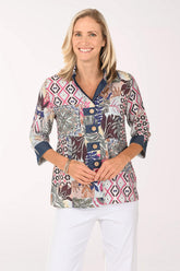 Woman wearing a multi colored button down top with 3/4 sleeves