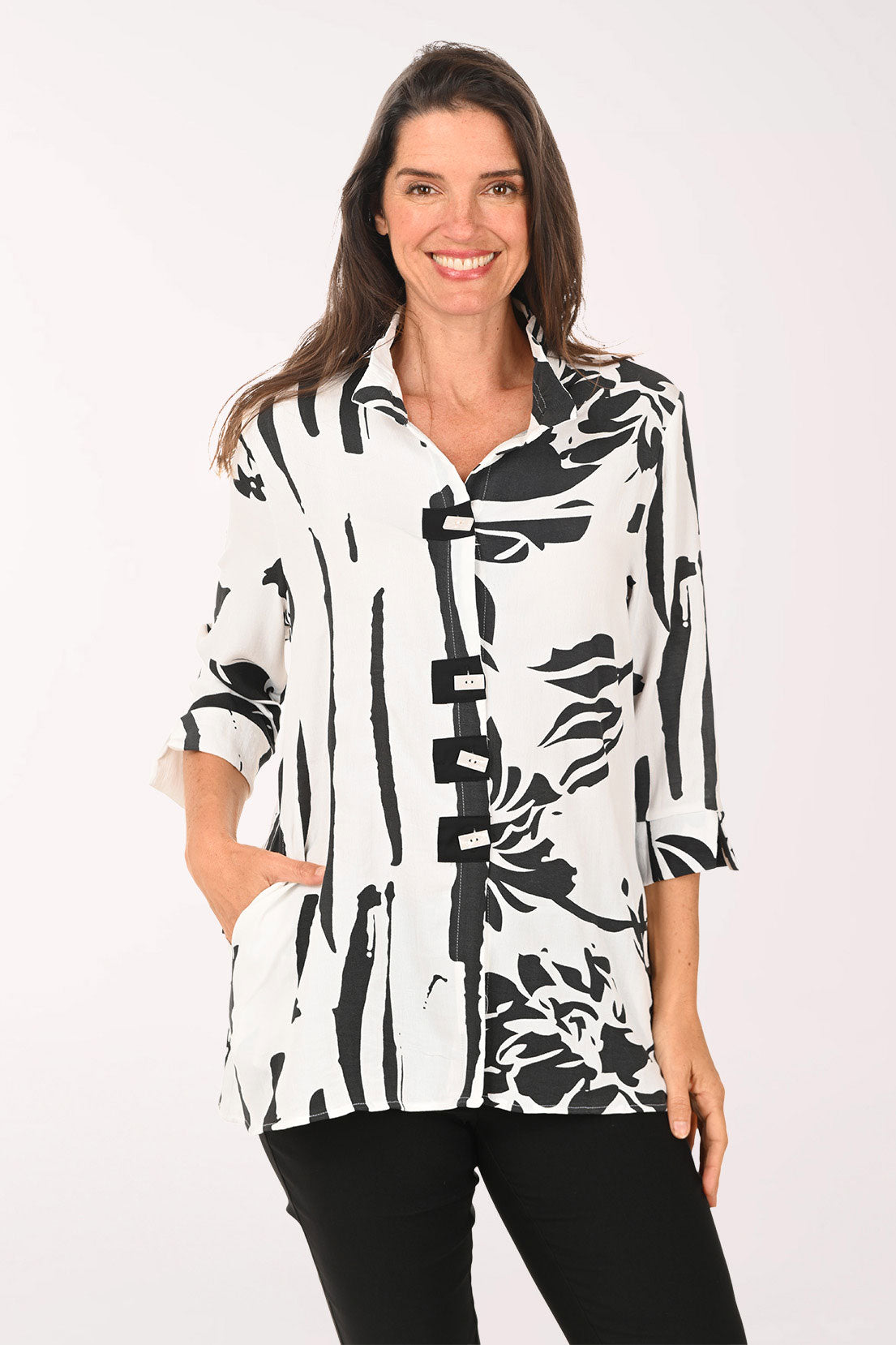 Woman wearing a black and white roll sleeve top