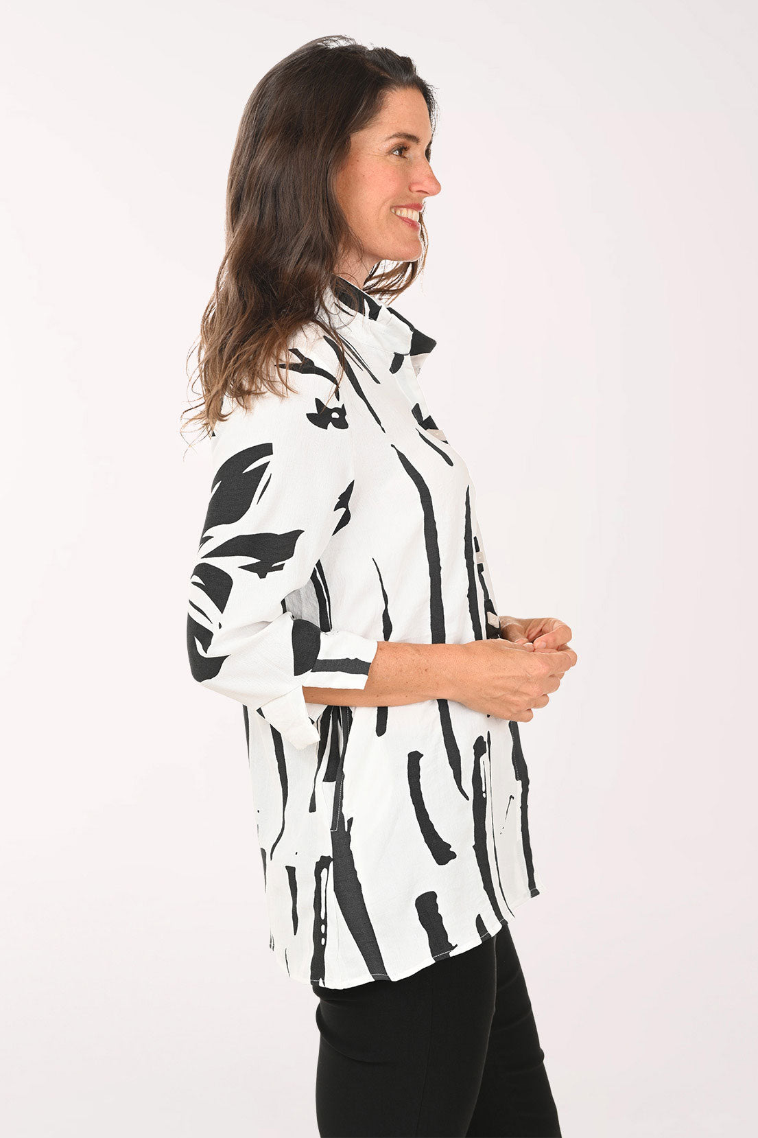 Woman wearing a black and white roll sleeve top