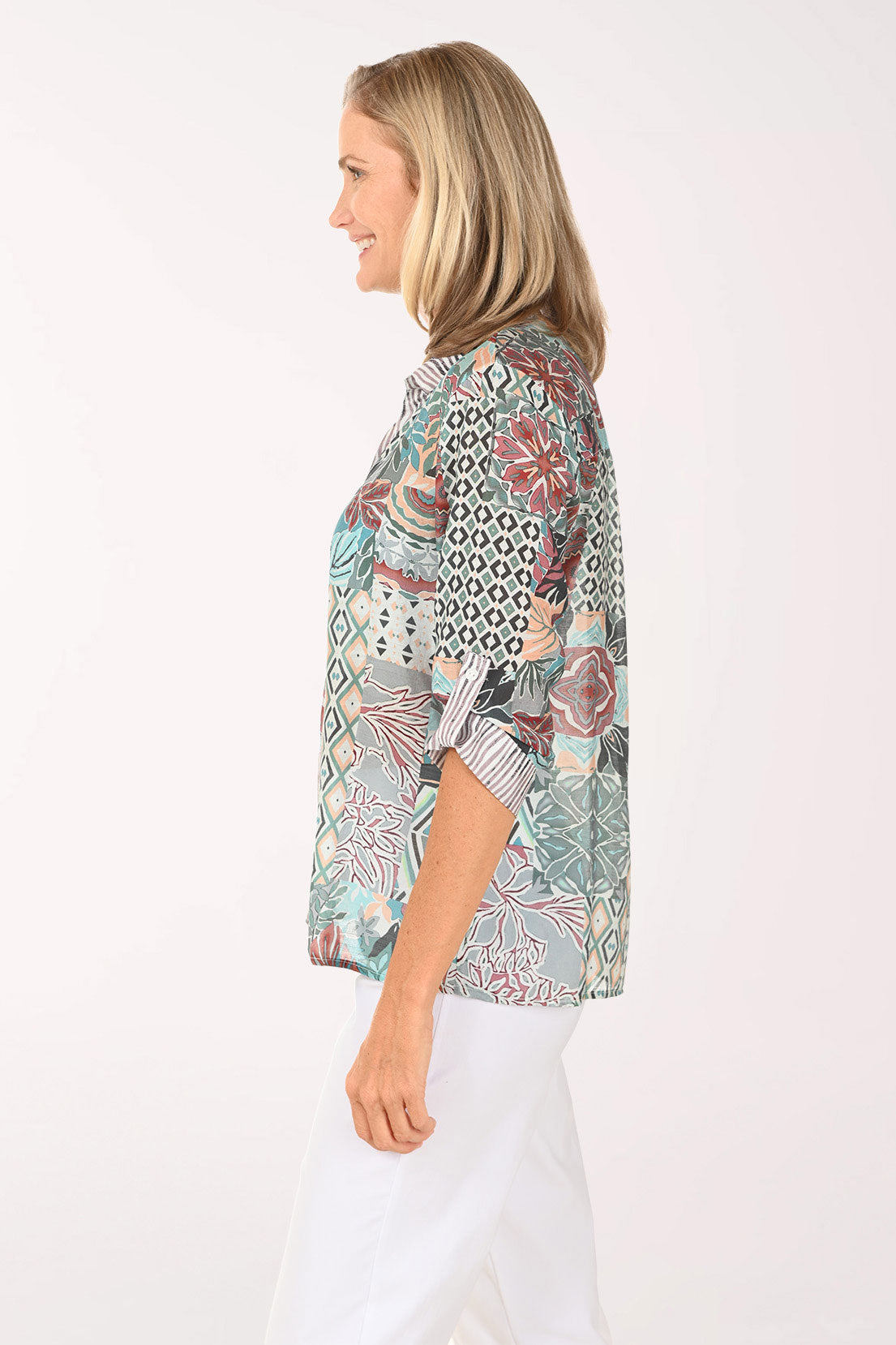 Woman wearing a multi colored roll sleeve top