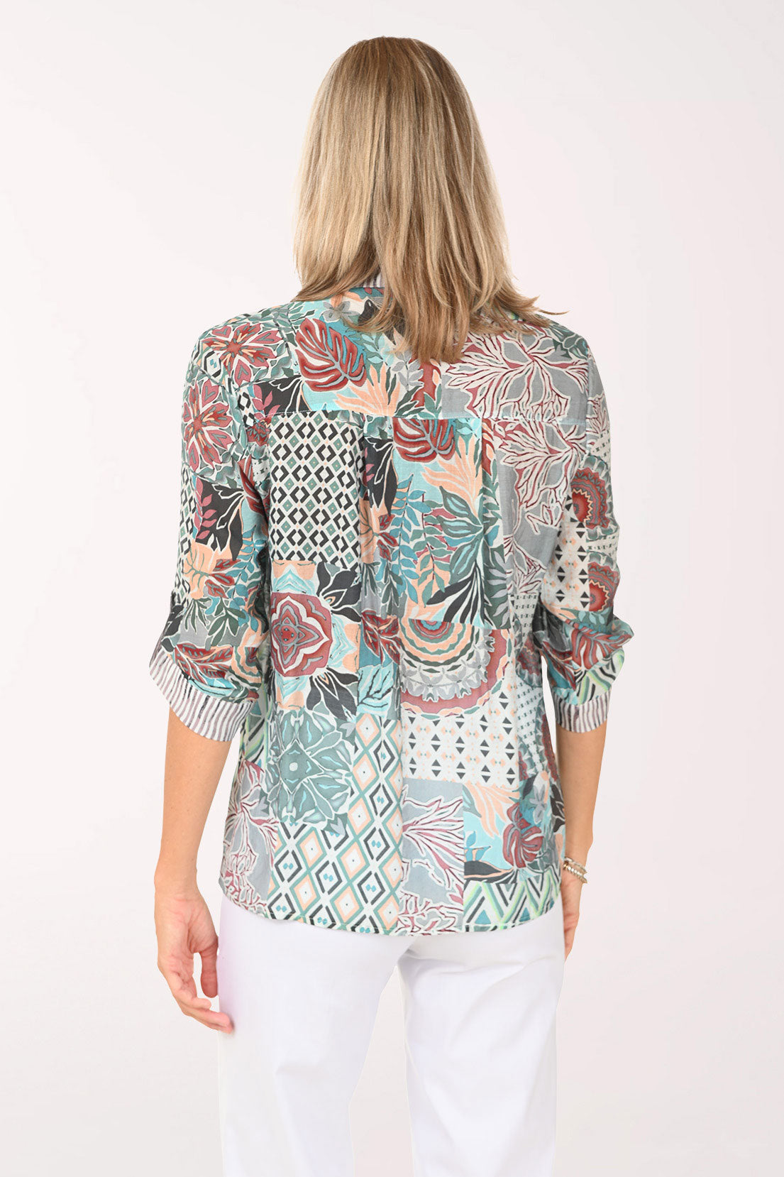 Woman wearing a multi colored roll sleeve top