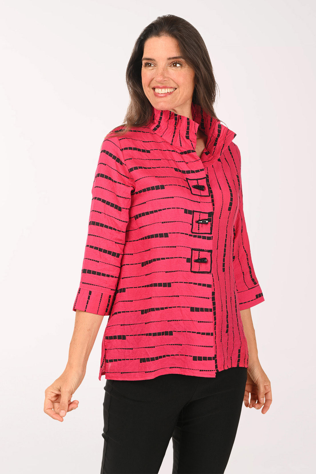 Woman wearing a pink top which black striped details