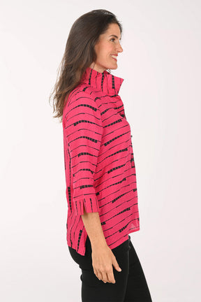 Woman wearing a pink top which black striped details