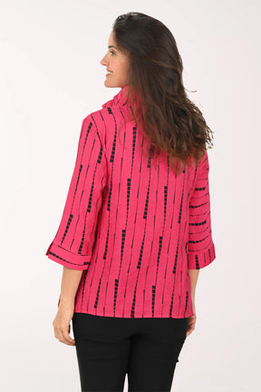 Woman wearing a pink top which black striped details