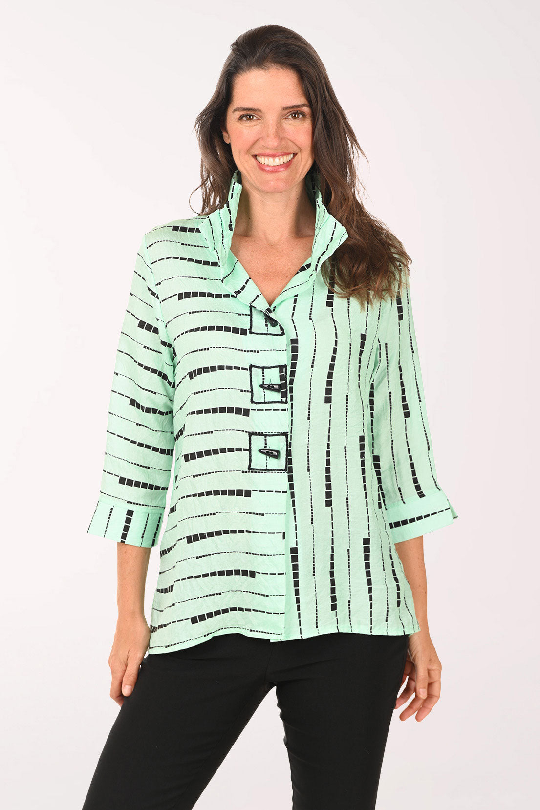 Woman wearing a green top which black striped details