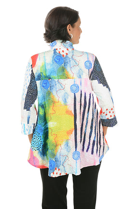 Woman wearing a colorful patterned blouse on a white background. Back shot.