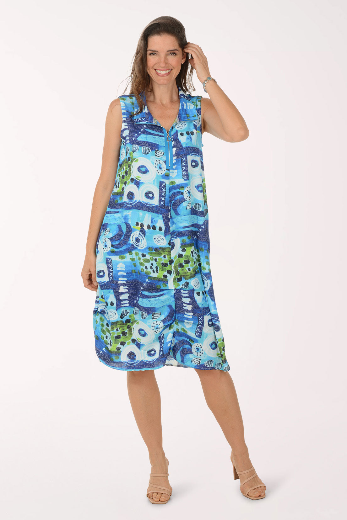 Woman wearing a blue and green patterned dress on a white background