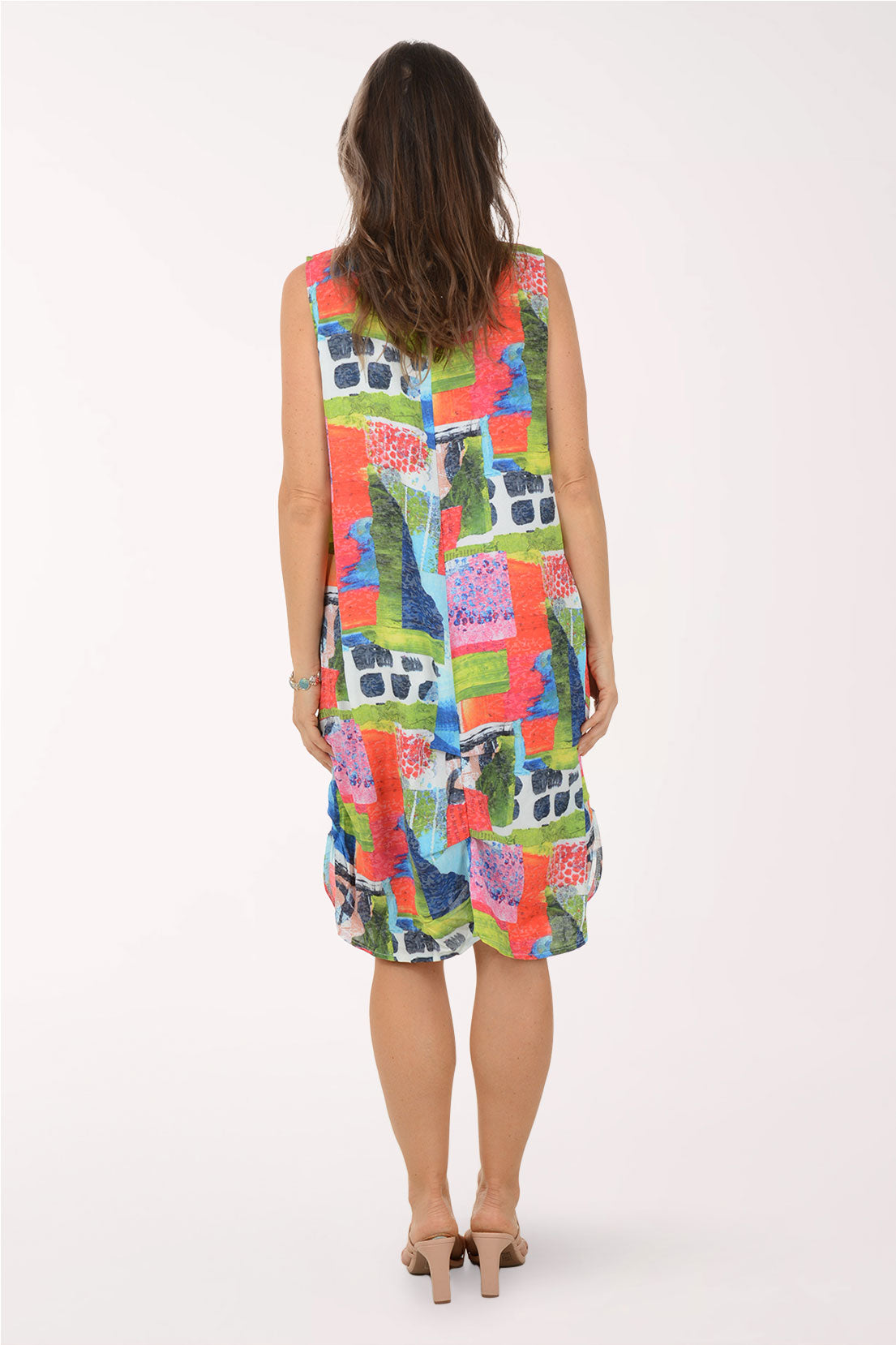 Woman wearing a colorful patterned dress on a white background