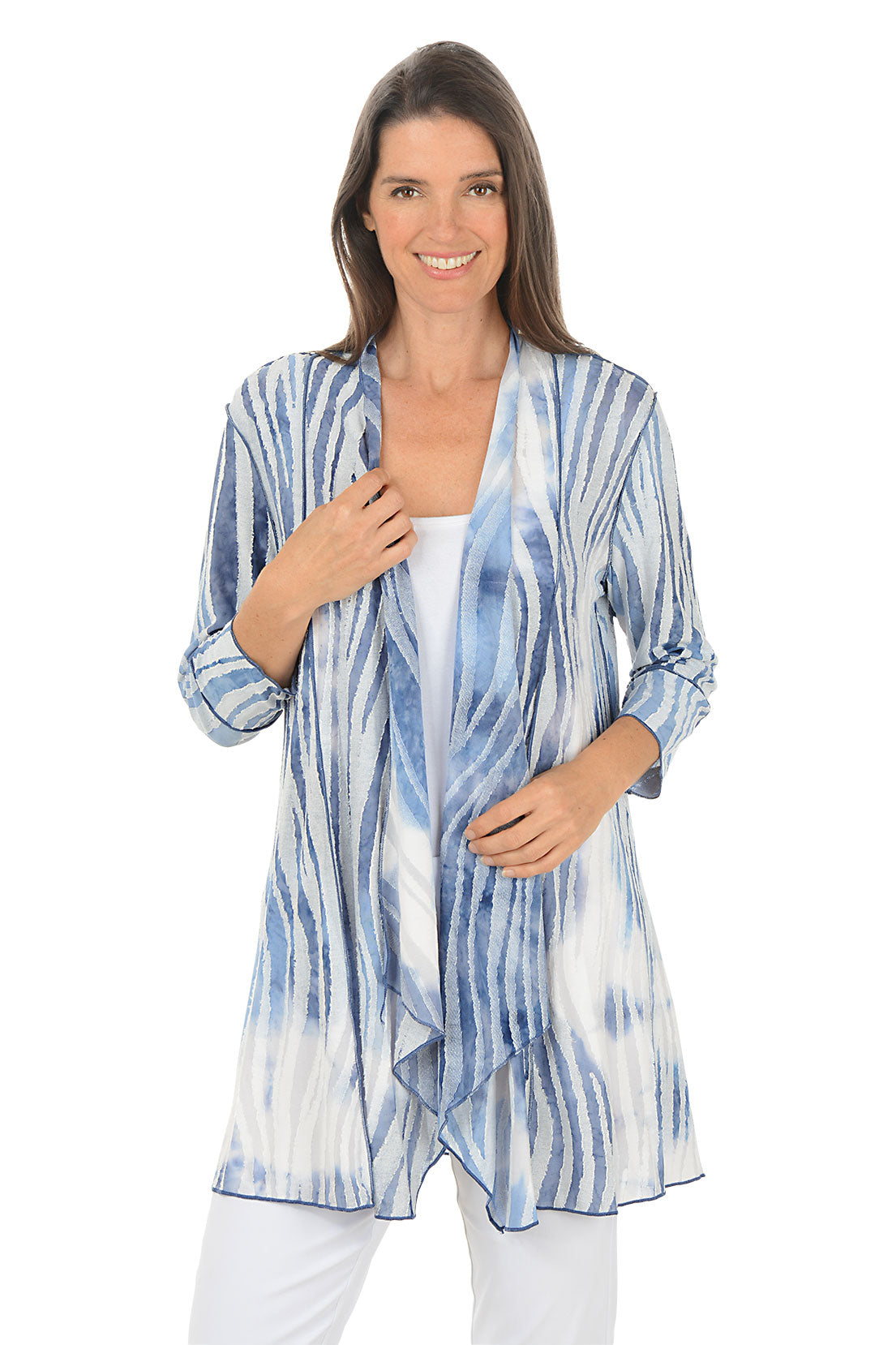 Woman wearing a blue and white tie-dye shirt on a white background. 