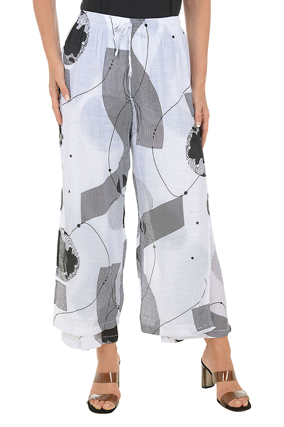 White pants with black and gray geometric pattern worn by a person on a white background.