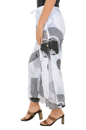 White pants with black and gray geometric pattern worn by a person on a white background. Side shot.