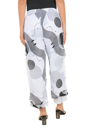 White pants with black and gray geometric pattern worn by a person on a white background. Back shot.