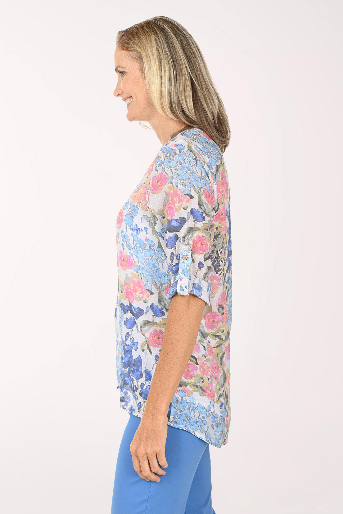 Woman wearing a multi color roll sleeve top