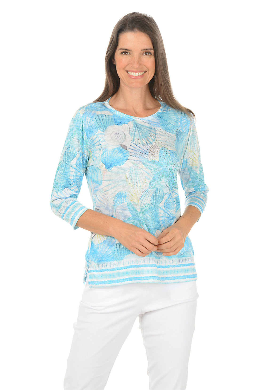 Woman wearing a blue patterned top on a white background. Second front shot.