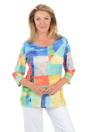 Woman wearing a colorful patchwork sweater on a white background.