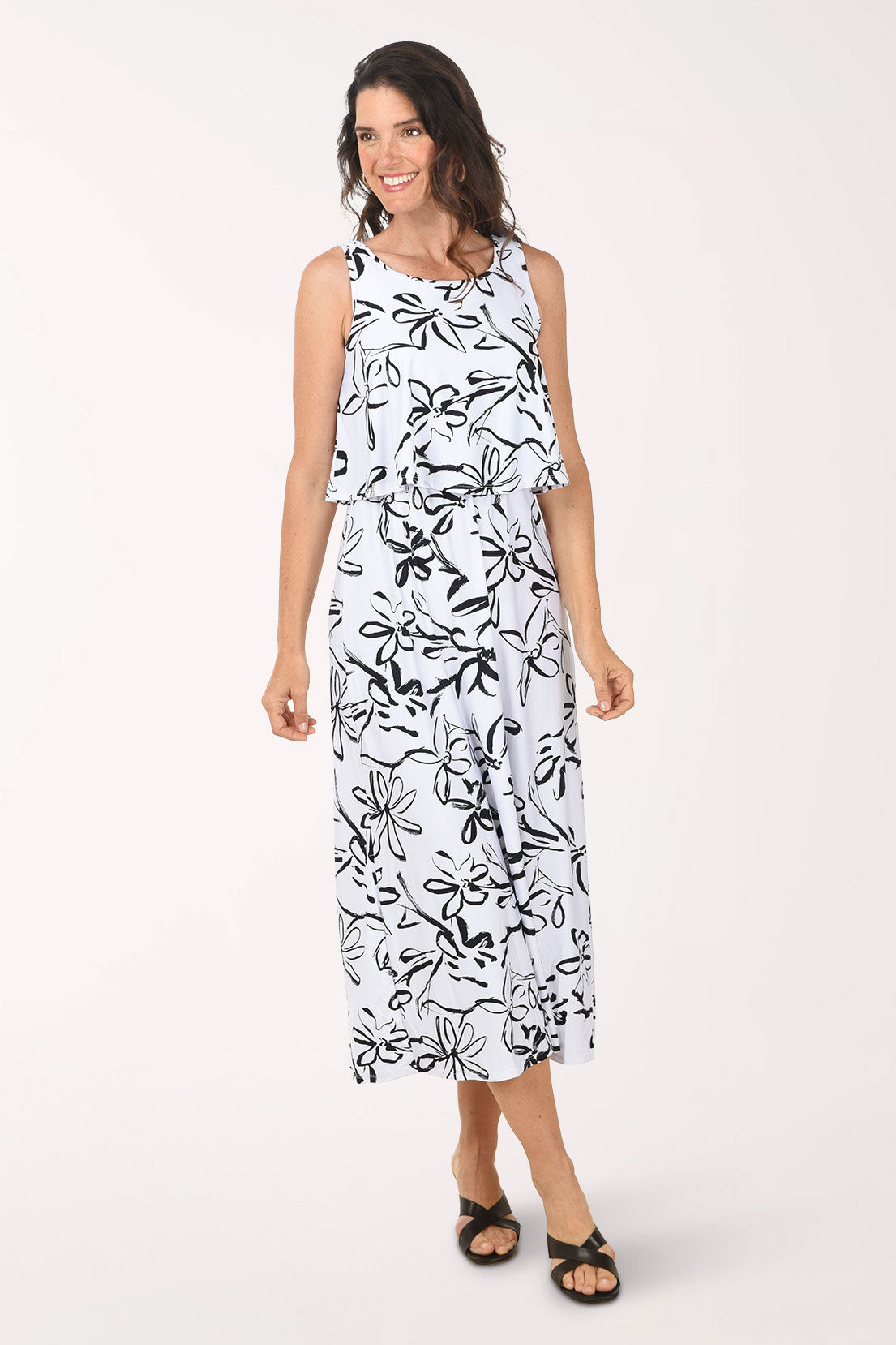 Woman wearing a black and white floral dress on a white background